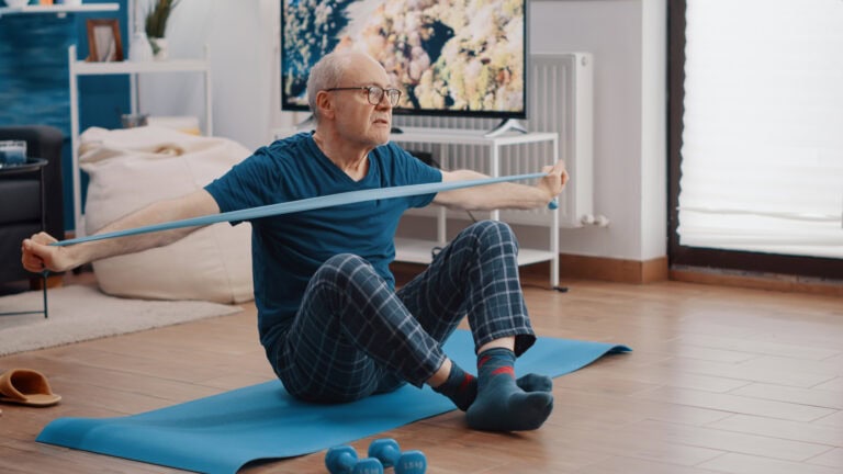 Retired senior in living room doing excersise